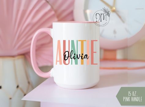 Celebrate the joy of family with our Personalized Auntie Mug, featuring a custom name option for a heartfelt touch. This Auntie Coffee Mug makes the perfect pregnancy reveal gift, honoring the special bond between aunt and soon-to-arrive niece or nephew. ✨ Ceramic DOUBLE-SIDED mug ✨ 11oz. (0.33 l) ✨ 15oz. (0.44 l) ✨ Dishwasher and microwave safe 🚫We do not accept exchanges, returns, or cancellations, however, if there are any quality issues with the item please contact us right away. We'll be happy to make things right and make sure you are satisfied with the item you purchased! PLEASE NOTE ✨ All pictures are shown for illustration purposes to reflect the final product.  ✨ Keep in mind colors may appear more vibrant on your screen Mom Cups, Pregnancy Reveal Gifts, Gift For Aunt, Pregnancy Reveal, Mug Personalized, Mug Custom, Pregnancy Reveals, Custom Name, Drinkware