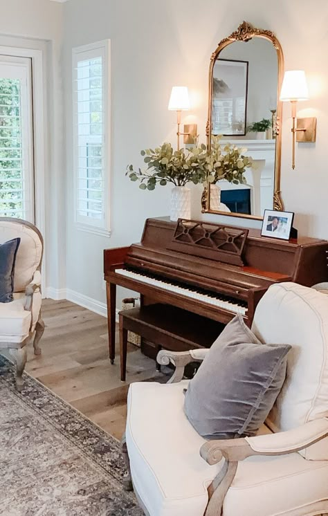 Piano With Sconces, Mid Century Classic Living Rooms, Cottage Piano Room, How To Style A Piano Decorating Ideas, Round Desk Table, Piano In Sitting Room, 1968 Home Aesthetic, Decor With Piano, Styling Top Of Piano