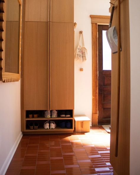 Stylish home entryway featuring white walls, elegant terracotta and pink tiles. The space includes a modern wooden wardrobe and a chic wooden mirror, creating a warm and inviting atmosphere. Color Drench Mudroom, Entrance Tiles Entryway, Log House Kitchen, Tile Entryway, Patio Floors, Gloss Texture, Terracotta Pink, Clay Imports, Backsplash Bathroom Wall