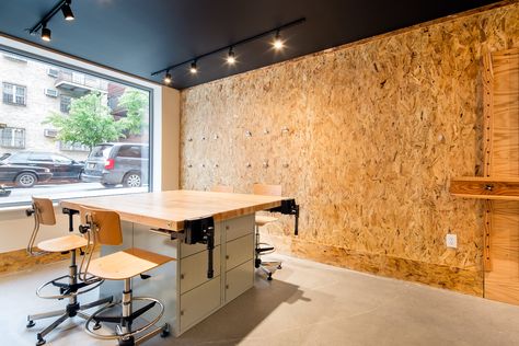 art studio in residential building, art work table, art stools, black ceilings, OSB board walls, wall hung art easels Osb Board Walls, Osb Board Interior, Osb Walls Ideas, Osb Ceiling, Chipboard Interior, Black Ceilings, Gray Interior Doors, Osb Furniture, Office Cube