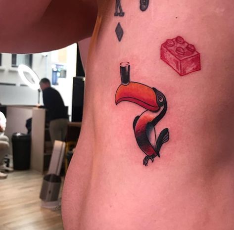 Guinness Toucan Tattoo, Guiness Tattoos, Bird Rib Tattoo, Guinness Tattoo, Beatles Inspired Tattoos, Toucan Tattoo, Road Tattoo, Bird Tattoo Ribs, Minimalistic Tattoos