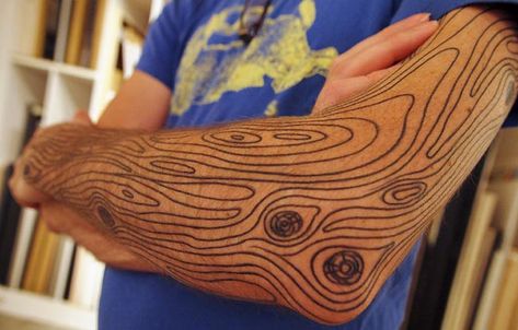 Wood grain. What a fun and unique idea. Wood Grain Tattoo Sleeve, Wood Texture Tattoo, Woodgrain Tattoo, Rugged Tattoo, Wood Grain Tattoo, Carving Tattoo, Grain Tattoo, Camping Tattoo, Wood Tattoo