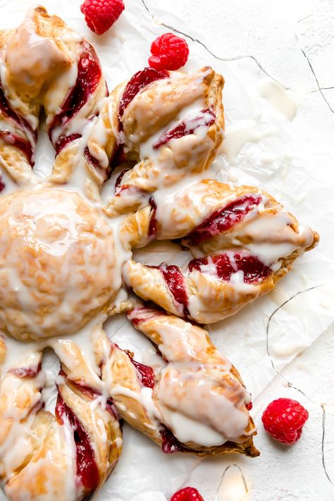 Give your holiday brunch menu a special upgrade with this extra-festive Christmas Kringle! This puff pastry kringle is filled with vanilla cream cheese & homemade spiced raspberry jam laced with the warmth of cinnamon, ginger, & nutmeg. Shape into a holiday star & finish with icing for the perfect kiss of sweetness, this raspberry kringle is a special addition to any Christmas morning. Easy to make & make-ahead friendly! #kringle #kringlerecipewithpuffpastry #christmasbreakfast #christmasburnch Christmas Breakfast Pastry, Puff Pastry Dessert Christmas, Christmas Kringle Recipe, Swedish Kringle Recipe, Christmas Danish, Puff Pastry Jam Recipes, Norwegian Kringle Recipe, Kringle Recipe Norwegian, Christmas Cooking Ideas Dinners