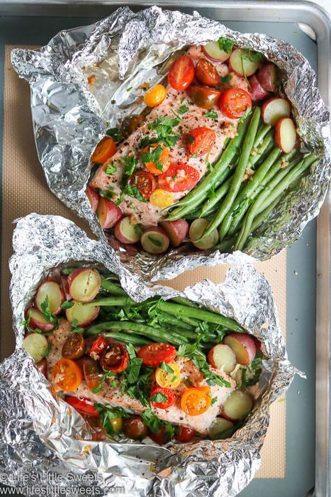 #ad - This healthy Salmon Foil Packets recipe has moist, delicious salmon filets, French cut green beans, mixed grape tomatoes, sliced onions, garlic, Italian parsley and whole red baby potatoes. All the ingredients are contained in the foil packets and  baked in the oven for 25 minutes. This makes an easy, satisfying meal. #tomatoes #garlic #greenbeans #potatoes #onions #recipe #MazolaHeartHealth #CollectiveBias #salmonfoilpackets #salmon #fish #dinner @MazolaBrand www.lifeslittlesweets.com Salmon Foil Packets Oven Potatoes, Foil Packets For The Oven Salmon, Fish In Foil Packets Ovens, Salmon In Foil In Oven, Salmon Packets Oven, Fish Foil Packets For The Oven, Salmon Foil Packets Oven, Salmon Foil Packets Grill, Fish Foil Packets