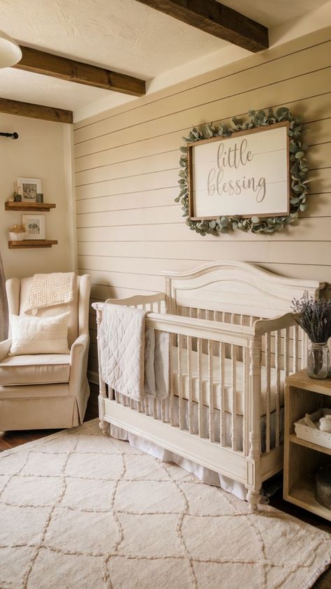 A rustic baby girl nursery with a distressed white crib, shiplap walls, a eucalyptus wreath around a “Little Blessing” sign, and a cozy beige rocking chair with soft throws. The room is completed with neutral tones, wooden shelves, and a plush cream rug for a farmhouse charm. Rustic Baby Girl Nursery, Shiplap Nursery, Baby Girl Nursery Ideas, Girl Nursery Ideas, Nursery Inspiration Girl, Wood Crib, Shiplap Walls, Baby Girl Nursery, Cream Rug