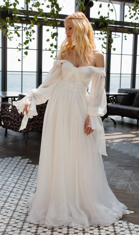 Esmee wedding dress | Boho Bohemian Collection 2021 | La Petra by Anna Sposa Group. Simple elegant wedding dress boho bohemian style. Classy white color modest wedding dress. Off the shoulder wedding dress with long sleeves. Inetersting bodice with draping. Wedding dress with belt. Modern modest wedding dress for elegant bride. Light airy wedding dress 2020. Boho wedding dress bohemian. Boho Wedding Dress With Off The Shoulder Sleeves, Off The Shoulder Poofy Sleeve Wedding Dress, Off The Shoulder Wedding Dress Flowy, Boho Minimal Wedding Dress, Billowy Sleeve Wedding Dress, Folksy Wedding Dress, Peasant Sleeve Wedding Dress, Flowy Off The Shoulder Wedding Dress, Flowy Ethereal Wedding Dress