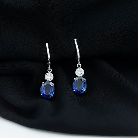 Product Details Elevate your style with these stunning Drop Earrings. The brilliant blue hue of the oval cut created blue sapphire is complemented by the sparkling round zircon, all set in a luxurious gold with lever-back design. Perfect for adding a touch of glamour to any outfit, these created sapphire earrings are a must-have for any fashion-conscious individual. Product Information SKU SHP-EARRINGS042310002 Weight 2.93 gm (Approximate) LAB CREATED BLUE SAPPHIRE INFORMATION No.of Stones 2 Pie Dangly Earrings, Sapphire Earrings, Delicate Earrings, Sapphire Gemstone, Silver Earrings Dangle, Oval Cut, Blue Sapphire, Wedding Jewelry, Dangle Drop Earrings