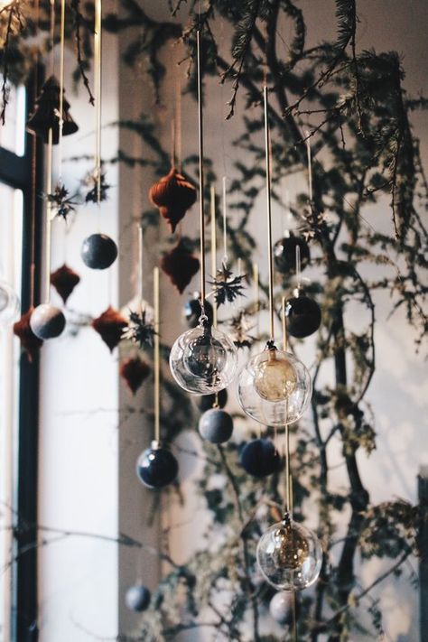 Christmas window decor done with fir branches and some chic sheer and colored ornaments hanging down Christmas Window Decorations, Dark Christmas, Christmas Tablescape, Christmas Interiors, Christmas Inspo, Nordic Christmas, Christmas Window, Noel Christmas, Magical Christmas