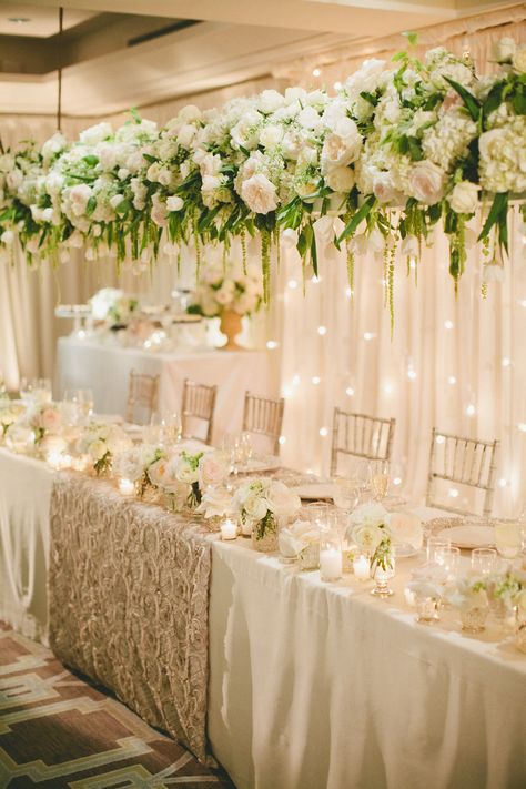 A longer view of the panel table. Gorgeous floral arrangement hanging above. Tablecloth Photography, Dreamy Tablescapes, Head Table Wedding Decorations, Head Table Decor, Table Flower Arrangements, Head Table Wedding, Floral Installation, Classic Wedding Decorations, Bridal Table