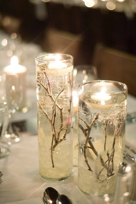 I designed my winter wedding around the idea of snow filled forest, using natural pieces like twigs, bark, and fire to make it warm and cozy. The guests all commented on the warm and classic feel and the not-overly-obvious theme. My colours were champagne, navy and ivory. I am selling the majority of my decor; please see a list below:  Extra Large Vases (shown with flowers), including "ice rock" and twigs, tulle optional: x8 [Diameter 6 ¼ ", Height: 26 ¾ "]  $30.00 each or $225 for 8 // ... Fire And Ice Wedding, Ice Wedding, Ice Party, Ice Rock, Wedding Forest, Large Vases, Snow Wedding, Snow Theme, Gel Candles