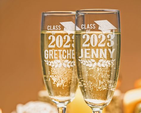 "ONE Champagne Glass with Class of 2023 Graduation Hat Design and Personalized with Name. IMPORTANT!! GLASS WILL COME WITH THE YEAR OF 2023 UNLESS SPECIFIED OTHERWISE. Gift for the Newly Graduated women, men, thoughtful and memorable keepsake that they will treasure for years to come. Perfect for college dorm room decor or toasting to their success, our champagne flute is a unique and practical gift that they will love. And with the option to add your name, you can make their graduation day even Graduation Champagne, Graduation Hat Designs, College Dorm Room Decor, 2023 Graduation, Graduation Hat, College Dorm Room, 2024 Graduation, Class Of 2023, Hat Design