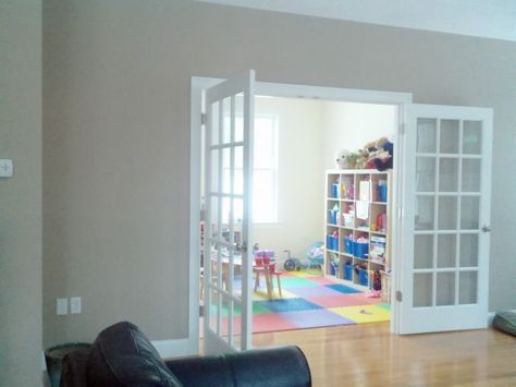 French door idea for entry to playroom. Might help keep it quieter in the house...maybe Playroom With Pocket Doors, Basement With French Doors, Playroom With Sliding Glass Doors, French Door Playroom, Playroom Door Ideas, French Door In Garage To Basement, Playroom Curtains, White French Doors, Navy Bedrooms