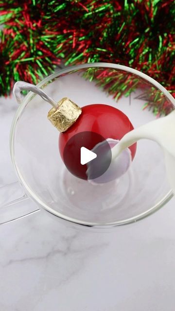 Erin | Caker & Content Creator | Point Pleasant, NJ on Instagram: "Easy ornament cocoa bombs.  You could even add a little sparkle to your chocolate ornament with luster dust.  I used a @rolochocolate and edible gold leaf for the top and made a chocolate hook sprayed with @sweettoothfairy glitter spray. 
•
•
#hotcocoa #hotcocoabombs #cocoabombs #hotcocoabombtutorial #chocolate #christmas #christmasdecor #hotchocolate #foodnetwork #foodhacks #foodvideo #holidaydrinks #holidaycake #christmascookies #baker #bakersofinstagram #f52grams #foodie #chocolatelover #easyrecipes #christmastree #foodphotography #foodporn #instafood" Chocolate Christmas Ornaments, Chocolate Ornament, Edible Gold Leaf, Easy Ornaments, Luster Dust, Glitter Spray, Point Pleasant, Edible Gold, Christmas Chocolate