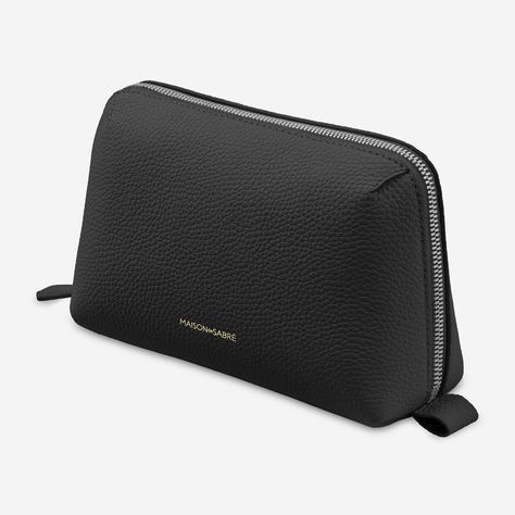 A minimalistic case to fit inside any bag or backpack and meticulously organise electronic accessories. The Tech Pouch is a plush, multi-compartment design crafted from full-grain pebbled leather and technical stretch fabric to safeguard cables, chargers, SD cards, AirPods and more within five purpose-built compartments. An internal zipped pouch secures smaller valuables while a striking clamshell silhouette and structured base ensures it stands forever upright, minimising surface occupancy and Tech Pouch, Sustainable Leather, Hand Painted Leather, Black Travel, Blue Gift, Black Caviar, Painting Leather, Toiletry Bags, Travel Pouch