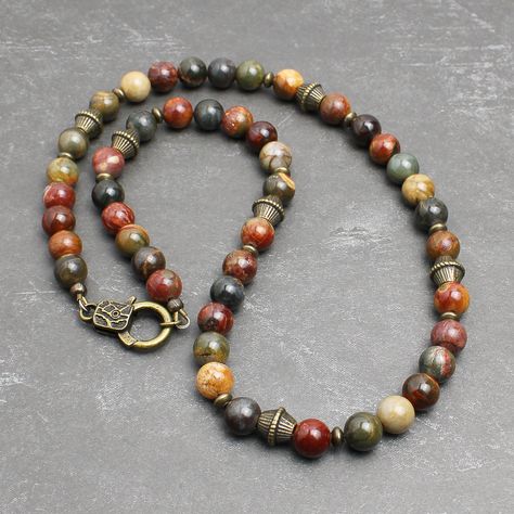 "* Made with Red Creek Jasper 8mm round beads, which has the earthy multi-colors of tan, olive green, burnt red, charcoal gray, and more. The softly muted colors of this natural stone makes it great for both men and women. * Embellished with antiqued brass finish pewter beads and brass spacers. It closes with an unique looking lobster clasp in antiqued brass finish pewter. * Strung with a professional quality durable wire, which is made of 49-strand fine stainless steel bundled and nylon coated. Bead Necklace For Men, Red Creek Jasper, Earthy Jewelry, Dope Jewelry, Natural Stone Jewelry, Funky Jewelry, Jewelry Lookbook, Hippie Jewelry, Necklace For Men