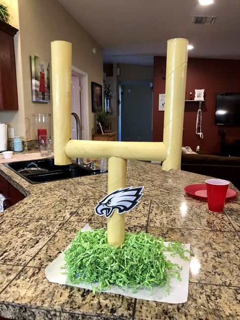 I made this football field goal from things around my house! The goal is made from paper towel rolls spray painted yellow. The base is a styrofoam square with Easter grass glued to it. Super Bowl party decor, DIY, football party. Philadelphia Eagles party. Philadelphia Eagles Snacks, Eagles Party Decorations, Eagles Theme Birthday Party, Philadelphia Eagles Decorations, Philadelphia Eagles Party Decorations, Diy Philadelphia Eagles Decor, Eagles Party Ideas Philadelphia, Philadelphia Eagles Birthday Party Ideas, Diy Football Decor