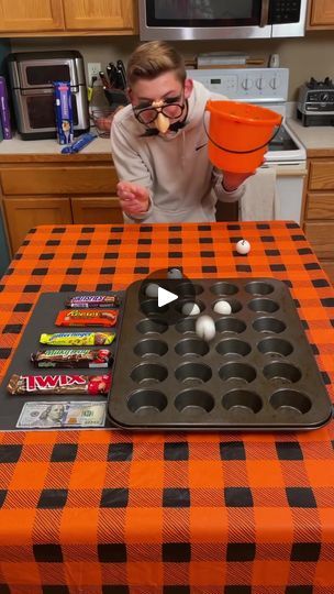 the Halloween Muffin Pan Challenge 🧁 | the Halloween Muffin Pan Challenge 🧁  Kids, Dad, Mom, and family play diy halloween game with ping pong balls and muffin tin at the kitchen table for... | By Family games fanFacebook Muffin Tin Game, Turkey Olympics, Halloween Muffin, Ping Pong Games, Games To Play With Kids, Diy Halloween Games, Halloween Games For Kids, Ping Pong Balls, Fall Fest