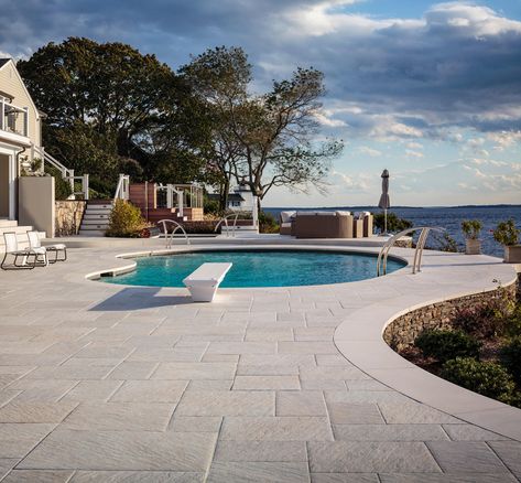 When designing a pool, the options often seem endless. Pool decking can be done with any number of materials — poured slab, tile, natural stone, brick, wood — so why choose pavers? Pool Pavers Decking, Pool Deck Material Options, Pool Decking Options, Cool Decking Around Pool, Pool House Ideas Backyards, Stone Around Pool, Florida Pools, Pool Lanai, Stone Pool Deck