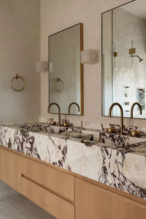 21 Stunning Modern Bathroom Ideas to Inspire Your Next Renovation Mounted Sink Powder Room, Leanne Ford Bathroom Design, Concrete Countertop Bathroom, Concrete And Marble Bathroom, Pink Marble Bathroom Ideas, Celebrity Bathrooms Master Bath, Marble And Wood Bathroom Ideas, Calcutta Bathroom, Dual Sink Bathroom Ideas