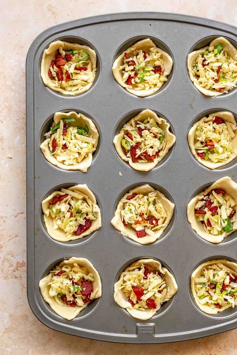 These mini quiche bites are easy individual quiches with a flaky crust and a creamy filling with bacon and cheese. And they are easily customizable with all different kinds of fillings. Because these quiche use pre-made puff pastry, they are simple to make with kids of all ages. These puff pastry quiche cups are perfect for brunch, parties, showers, and cocktail parties because they can be eaten in one bite and can be made ahead and reheated. They also freeze really well! Mini Quiche Recipes Puff Pastry, Mini Quiche Bites, Individual Quiches With Crust, Mini Quiches In Muffin Tin Puff Pastry, Quiche Muffin Recipes, Puff Pastry Quiche Recipes, Individual Quiche Recipes, Puff Pastry Mini Quiche, Quiche With Puff Pastry