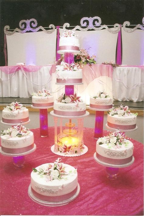 Alexis La Quinceanera cake - Tiered white and chocolate Tres Leches cakes filled with a vanilla mousse displayed on glass vases filled with pink water beads, led lighting and handmade gum paste flowers. Cakes With Lights, Staircase Wedding Cake, Cake Quinceanera, Sweet 15 Cakes, 15 Cakes, Quinceañera Cakes, Fountain Wedding Cakes, Chocolate Tres Leches Cake, Bling Wedding Cakes