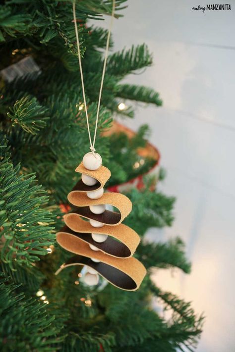 These DIY leather ornaments fit right in with the modern farmhouse home decor style and are such a great budget-friendly Christmas craft! This easy to follow tutorial will walk you through how to make this leather ornament that looks like a mini Christmas tree with wood beads.