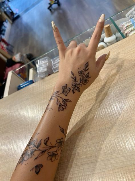 Tattoos With Deep Meaning For Black Women, Hand Tattoos Wrap Around, Cute Outline Tattoos For Women, Tiger Lily Vine Tattoo, Arm Sleeve With Small Tattoos, Leo Forearm Tattoo Women, Floral Wrap Around Tattoo Forearm Color, Hibiscus Flower Back Tattoos, Girly Arm Sleeve Tattoos