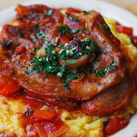 Authentic Italian Osso Bucco: veal shanks slowly braised with vegetables in tomato sauce and white wine until the meat falls of the bone.   Topped with another Italian classic: Gremolata (a condiment made with parsley, lemon zest, and garlic).  The veal shanks are served over creamy polenta or saffron risotto (Risotto Alla Milanese).   Osso Buco...Read More Best Osso Bucco Recipe, Oso Bucco Recipe, Shank Recipes, Veal Osso Bucco, Osso Bucco Recipe, Julia's Album, Beef Shanks, Osso Buco Recipe, Milanese Recipe