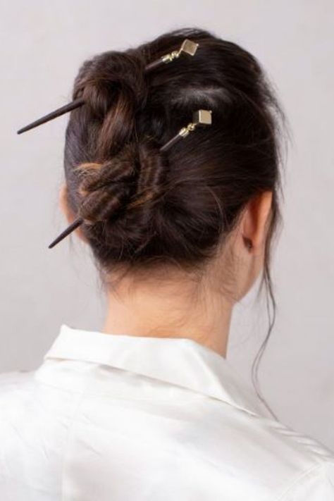 Woman with brown hair in two buns with two hair sticks Hair Pins Hairstyles, Hair Stick Styles, Hairstick Hairstyles, Fun Hairdos, Bun Stick, Twisted Bun, Medieval Hairstyles, Foundation Swatches, Easy Hairdos