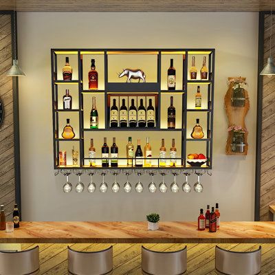 Williston Forge Joeziah Metal Wall Mounted Wine Bottle & Glass Rack in Black | Wayfair Small Bar Apartment, Wall Liquor Shelf, Bourbon Wall Display, Bar Unit Design, Alcohol Stand, Wall Bar Cabinet, Back Bar Shelving, Liquor Wall, Bar Shelf Ideas