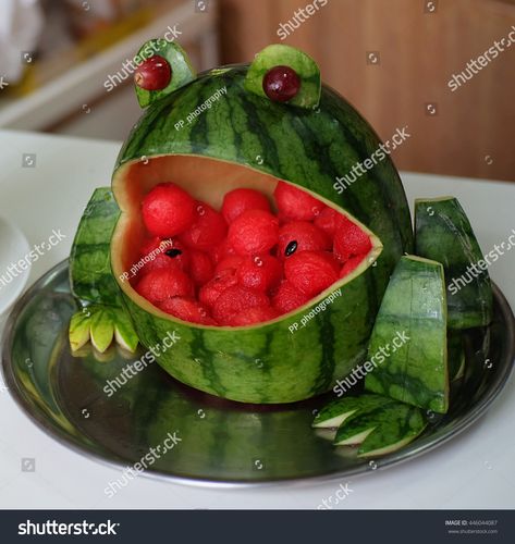 Carved watermelon frog from watermelon Watermelon Frog Fruit Bowl, Frog Watermelon, Watermelon Carving Graduation, Dinosaur Watermelon, Watermelon Carving Wedding, Watermelon Sculpture, Watermelon Frog, Watermelon Pig, Watermelon Carving Easy