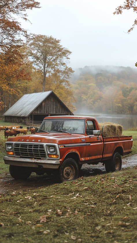 A vintage red Ford pickup truck parked in a field with hay bales in the back. There is a barn and a lake in the background, and the trees are turning red and orange. Vintage Truck Aesthetic, Country Trucks, Old Ford Trucks, Vintage Pickup Trucks, Classic Ford Trucks, Wilde Westen, Old Pickup Trucks, Old Pickup, Dream Trucks