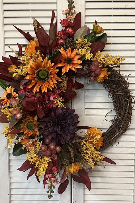 "A Grapevine wreath with red larkspur, red hydrangea, purple dahlia, orange sunflower, mixture of other fall flowers and fall foliage. 26\"x19\"" Purple Orange Wreath, Fall Wreaths For Front Door 2023, Red Larkspur, Mic Wallpaper, Dahlia Orange, Vine Wreaths, Thanksgiving Table Decor Ideas, Door Swags, Fall Aesthetics