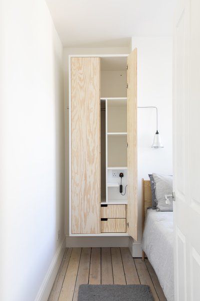 "Each wardrobe has got a rail, shelves, a couple of drawers, and a hook on the outside facing the wall for an extra hanging point," says Baulier. The pendant is the Roly Casper by Offdn in brushed aluminum. Wall Storage Ideas, Bedside Wardrobe, House Refurbishment, Cat Climbing Wall, Hanging Wardrobe, Wall Cupboard, Wall Hanging Storage, Bedroom Cupboard Designs, Built In Furniture