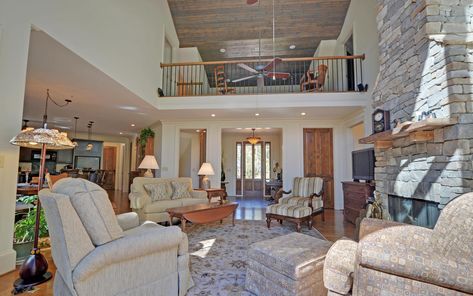 The great room and a view of the loft above with a look out space. The stone fireplace adds an accent to the room along with the vaulted T&G ceiling. Loft Ideas Upstairs Movie Room, Loft Over Living Room, Balcony Overlooking Living Room, House Plans With Balcony, Loft Ideas Upstairs, House Plans With Loft, Mountain Home Exterior, Industrial Farmhouse Decor, House Plan With Loft