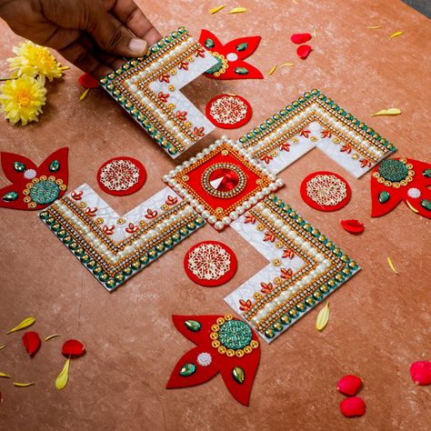 Welcome the Goddess of wealth, Laxmi, into your home with our ready-made Swastik rangoli. Our skilled artisans have intricately crafted this unique design using acrylic material, adorned with pearls, adding a touch of vibrancy to your festivals and home decor. Embrace the lively colors and positive energy of this rangoli, creating a warm and inviting ambiance during your festive celebrations. Swastik Design, Swastik Rangoli, Lotus Rangoli, Acrylic Rangoli, Goddess Of Wealth, Pooja Items, Rangoli Designs, White Stone, Ready Made