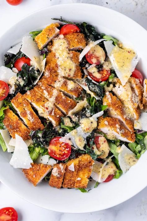 This chicken tender salad features perfectly crispy parmesan-crusted chicken tenders, massaged kale and green leaf lettuce, juicy tomatoes, shaved parmesan and a tangy parmesan vinaigrette. You can kiss boring salads goodbye because this simple crispy chicken salad recipe will be your new fave! Crispy Chicken Salad Recipe, Crispy Chicken Salad, Chicken Tender Salad, Crunchy Chicken Tenders, Crispy Chicken Salads, Homemade Fried Chicken, Crusted Chicken Tenders, Shaved Parmesan, Entree Dishes