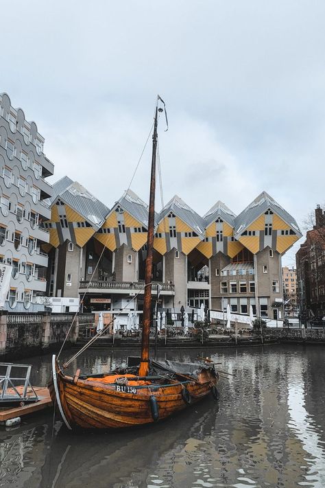 The yellow Rotterdam Cube Houses, with a bay of water and an old wooden boat in the foreground. Amsterdam Holland, Europe Aesthetic, Netherlands Travel, The Perfect Day, South America Travel, Vietnam Travel, Beautiful City, India Travel, Weekend Trips