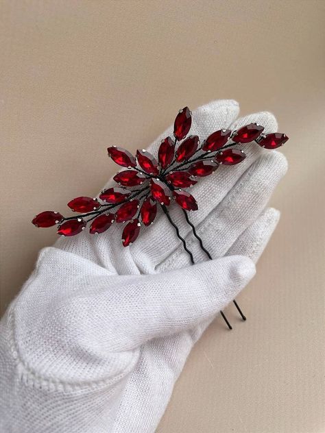 Looking for the perfect finishing touch for your bridal ensemble? Our exquisite black red hair pin is the ideal choice. Crafted with meticulous attention to detail, this bridal hair piece boasts a universal size, ensuring it complements any hairstyle effortlessly. Measuring approximately 4 inches in width, this elegant red hair accessory offers just the right amount of sparkle without overwhelming your look. Fashioned from luxurious crystal dark red rhinestones and intricately woven black jewelr Dark Red Hair Accessories, Red Hair Piece, Red Bridal Hair, Red Hair Pieces, Black Headpiece, Red Hair Accessories, Wedding Hair Pin, Cherry Red Hair, Black Red Hair