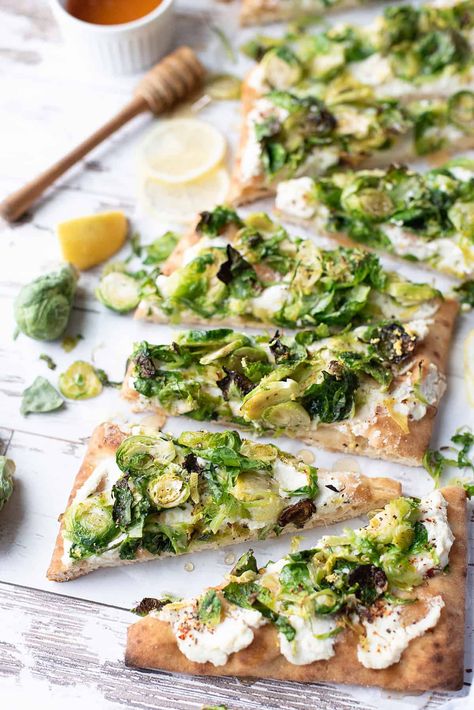 Sautéed Brussels sprouts, nestled on a bed of ricotta cheese with a honey drizzle: what's not to love? #vegetarianflatbread #vegetarianflatbreadrecipe #brusselssproutsrecipe #brusselssproutsflatbread #flatbreadrecipe Brussels Sprout Flatbread, Vegetarian Flatbread Recipes, Vegetarian Flatbread, Sautéed Brussels Sprouts, Goats Cheese Flatbread, Honey Drizzle, Recipe Journal, Lemon Ricotta, Flatbread Recipes