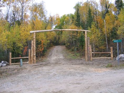 Wooden driveway log arch and fencing Driveway Arch, Amazing Driveways, Log Fence, Circle Driveway, Driveway Entrance Landscaping, Rustic Staircase, Farm Entrance, Beautiful Exterior, Hunting Land