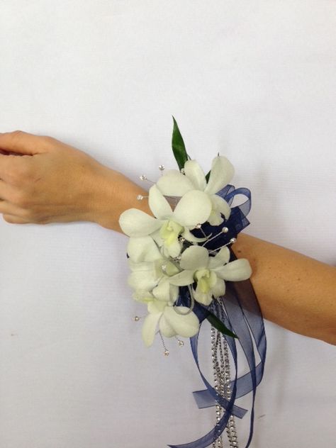 Wrist Corsage designed with a White Dendrobium Orchids. It's Accented with Ribbon and Crystals. Prom Corsage Ideas, Corsage Orchid, White Dendrobium Orchids, Corsage Ideas, Wedding April, Prom Corsage, Dendrobium Orchids, Corsage Prom, Wrist Corsage