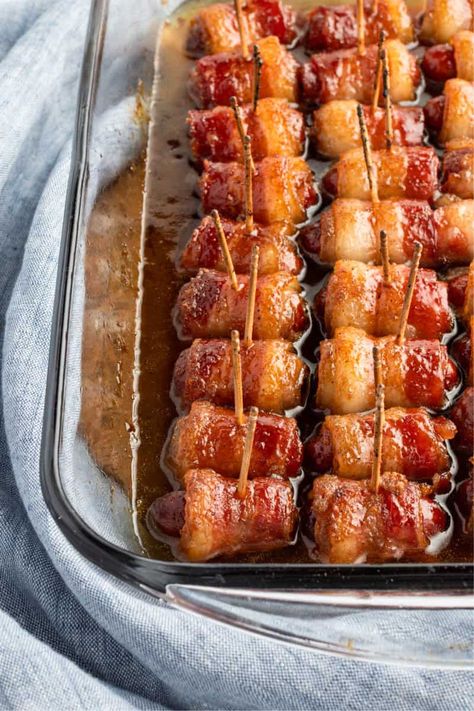 Easy Brown Sugar Bacon Wrapped Little Smokies are a perfect prep-ahead party bite! Be sure to make a double batch. They fly off the plate! #BreadBoozeBacon #littlesmokies #lilsmokies #sausages #bacon #brownsugar #partyfood #gameday #tailgating Party Host Snacks, Brown Sugar Weenies Bacon Wrapped, Little Weenies Wrapped In Bacon, Bacon Wrapped Brown Sugar Smokies, Bacon Weenies Brown Sugar, Bacon Wrapped Mini Weenies, Brunch Bacon Ideas, Bacon Wrapped Sausages With Brown Sugar, Brown Sugar Weenies