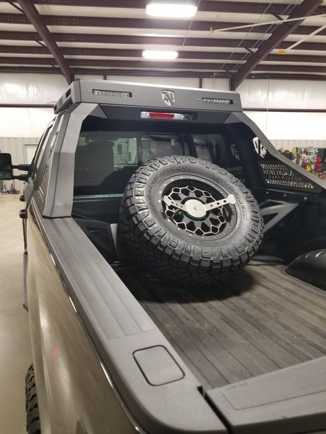 Angry Iron Metalworks spare tire mount Hilux Mods, Toyota Tacoma Bed Storage, Tacoma Long Bed, Truck Bed Spare Tire Mount, Pump Track, Tacoma Spare Tire Mount, Jeep Gladiator Spare Tire Carrier, Overland Build, Tacoma Front Bumper