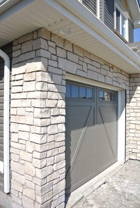 Garage with Sandstone Facing Stone Around Garage Doors, Sandstone Garage Door, Stone Garage, Stone Foundation, Garage Door Paint, Sandstone Color, Garage Exterior, Home Exterior Design, Garage Door Design