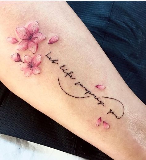 24 Fascinating Cherry Blossom Tattoo Designs For 2021 Cherry Blossom With Words Tattoo, Flower Signature Tattoo, Cherry Blossoms Tattoos For Women, Small Flowers Tattoo Design, Cherry Blossom Infinity Tattoo, Sakura Tattoo Design Cherry Blossoms, Cherry Blossom Tattoo With Names, Cherry Blossom Name Tattoo, Cherry Blossom Tattoo On Back Spine