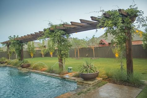 Incredibly long, verdant wooden trellis edging a formal swimming pool. Designed and Installed by Red Valley Landscape & Construction  in Oklahoma City, OK. Trellis By Pool, Pool Arbor Ideas, Pool Trellis Ideas, Pergola By Pool, Pool Trellis, Potters Bench, Oklahoma Landscape, Yard Trellis, Exterior Cottage