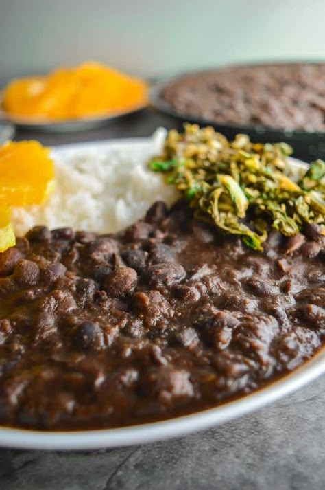 This delicious vegan and vegetarian version of the iconic Brazilian feijoada stew recipe is meat-free and stuffed with black bean goodness! Black beans and rice with greens and orange on the side and a sprinkle of toasted manioc flour if you can get it, luscious umami goodness! You can make this recipe in a pressure cooker, in the Instant Pot, or on the stove-top with dried or canned beans. Make it today and expand your black beans recipes repertoire! Brazilian Black Bean Stew, Brazilian Black Beans And Rice, Vegan Black Beans Recipe, Black Bean Recipes Vegetarian, Black Bean Stew Recipes, Brazilian Rice And Beans, Stewed Black Beans, Vegetarian Black Bean Recipes, Brazilian Beans And Rice