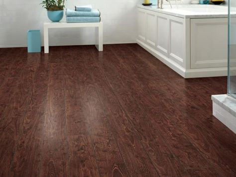 Learn more about how to choose and install laminate flooring in basements with these tips from HGTVRemodels. Dark Laminate, Fake Wood Flooring, Bathroom Flooring Options, Laminate Flooring Bathroom, Laying Laminate Flooring, Laminate Flooring In Kitchen, Basement Flooring Options, Wood Floor Bathroom, Small Basement Remodel