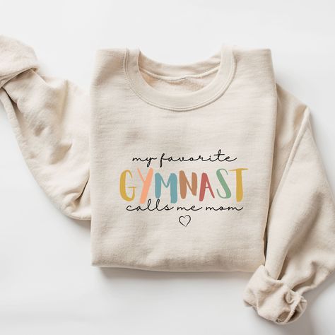 Gymnastics mom sweatshirt, Gymnastics mom shirt, Mom Gymnastics shirt, Gift for Gymnastics mom, gymnastics mom hoodie, proud gymnastics mom, gymnast mom  ♥ WHY YOU WILL LOVE YOUR SWEATSHIRT ♥ * Unique cute gift for everyone that is incredibly easy and stress-free to order & receive * Design is a the words Golden mama writing with trendy retro color and font. * Softest quality 50% cotton, 50% polyester with loose fit that runs true to size (unisex) * Extreme comfort with no bulky side seams for g Gymnastics Family Shirts, Mom Life Shirt Ideas, Dance Team Shirts, Gymnastics Mom Shirt, Gymnastics Shirts, Gymnastics Mom, Mama Hoodie, Cottagecore Outfits, Mom Sweater